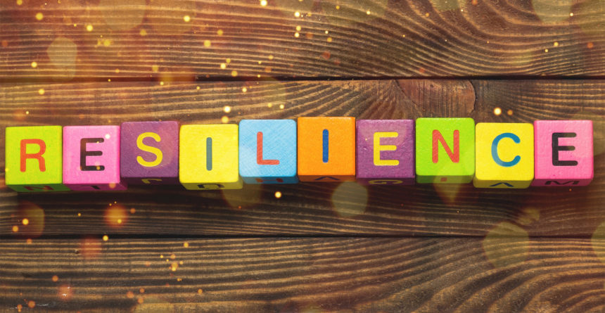 Resilience sign with wooden cubes on background