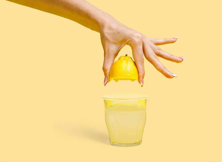 squeezing lemon into water