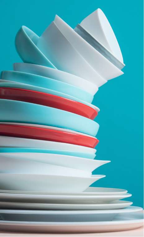 tall stack of dishes about to fall over